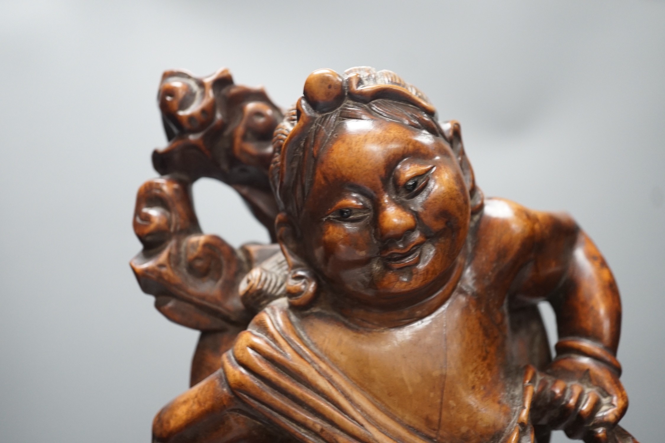A large Chinese hardwood figure of Liu Hai, early 20th century, 47cm